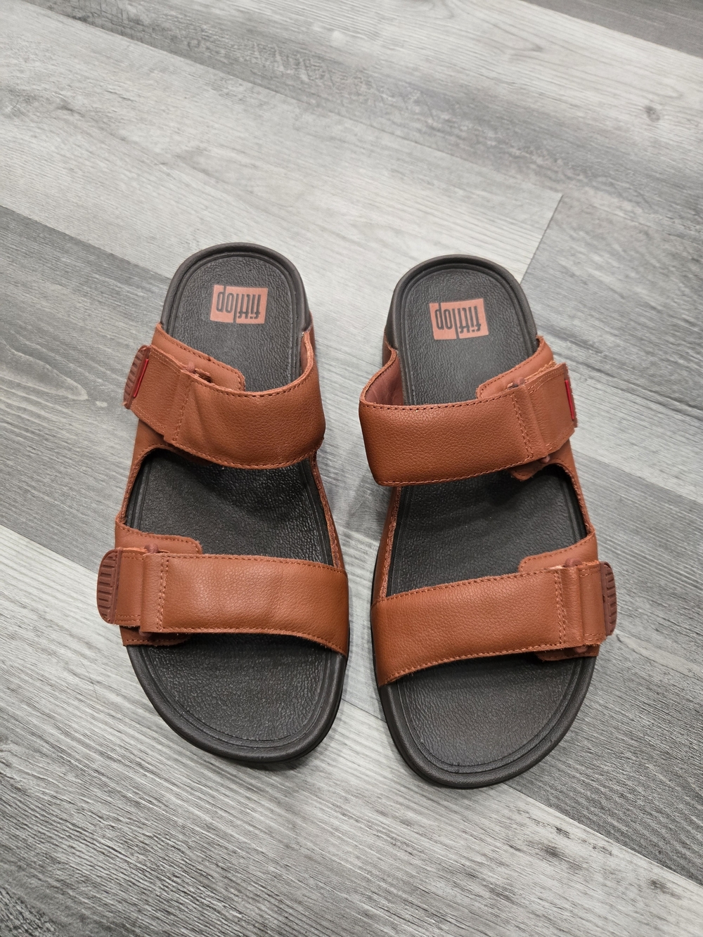 FitFlop Men's Gogh Moc Adjustable Strap Slide Sandals in the Dark Tan color